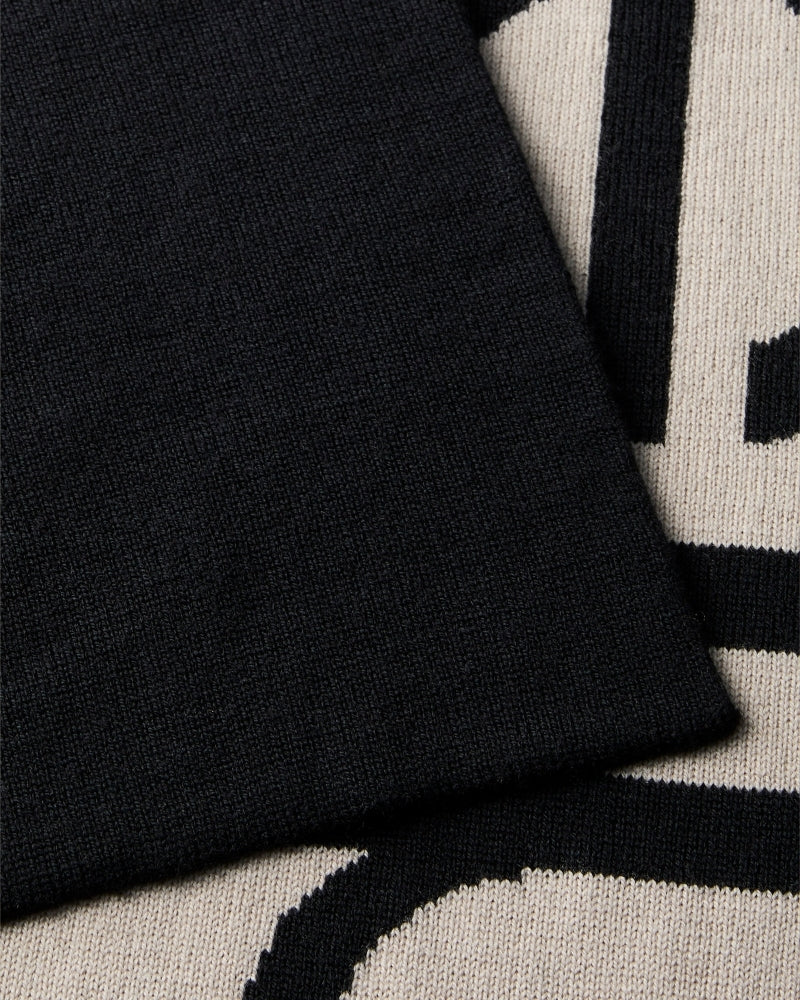 Close-up of CK logo on black and contrasting tone scarf
