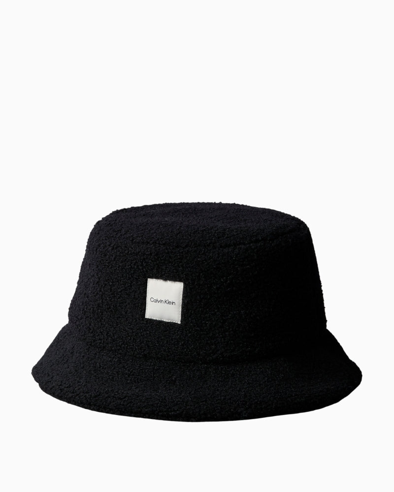 Front view of Calvin Klein black bouclé bucket hat with tonal patch logo