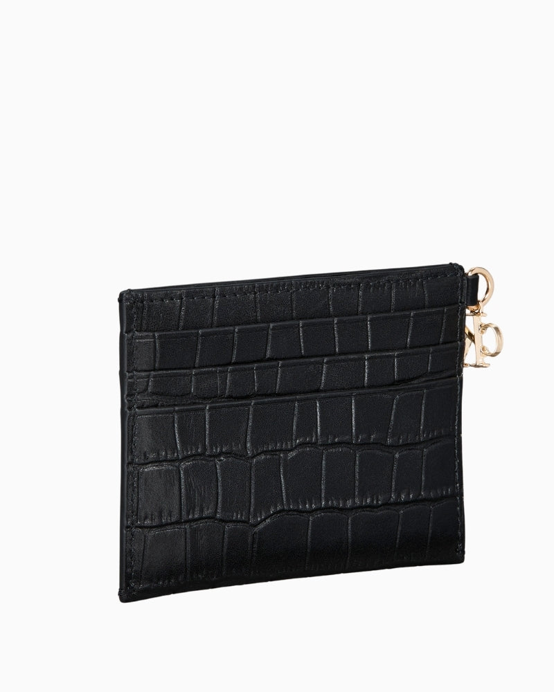 Side profile showing slim leather card holder with embossed texture