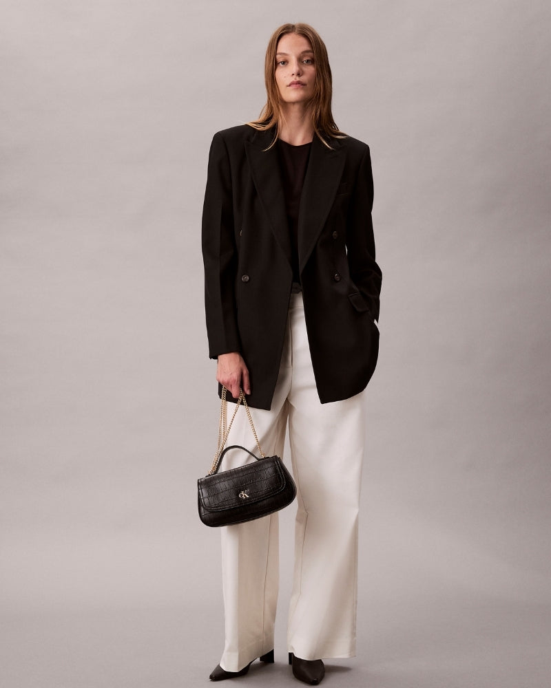 Ergonomic front view of Calvin Klein black croc top-handle bag with chain accent