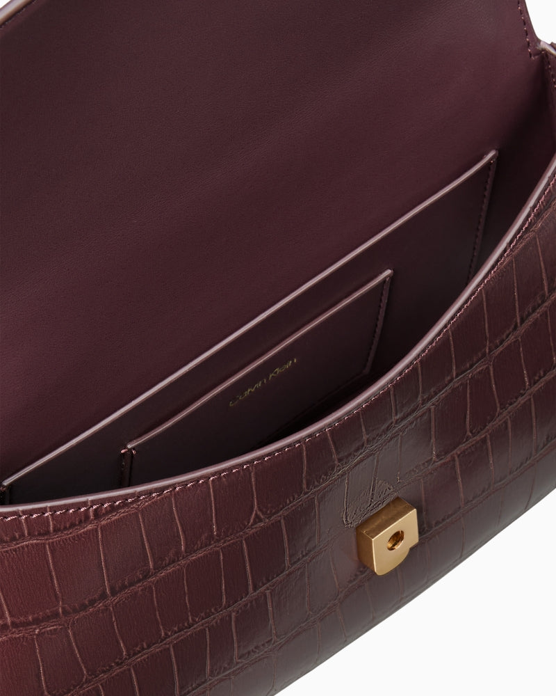 Close-up of chain strap and croc texture on Calvin Klein bag