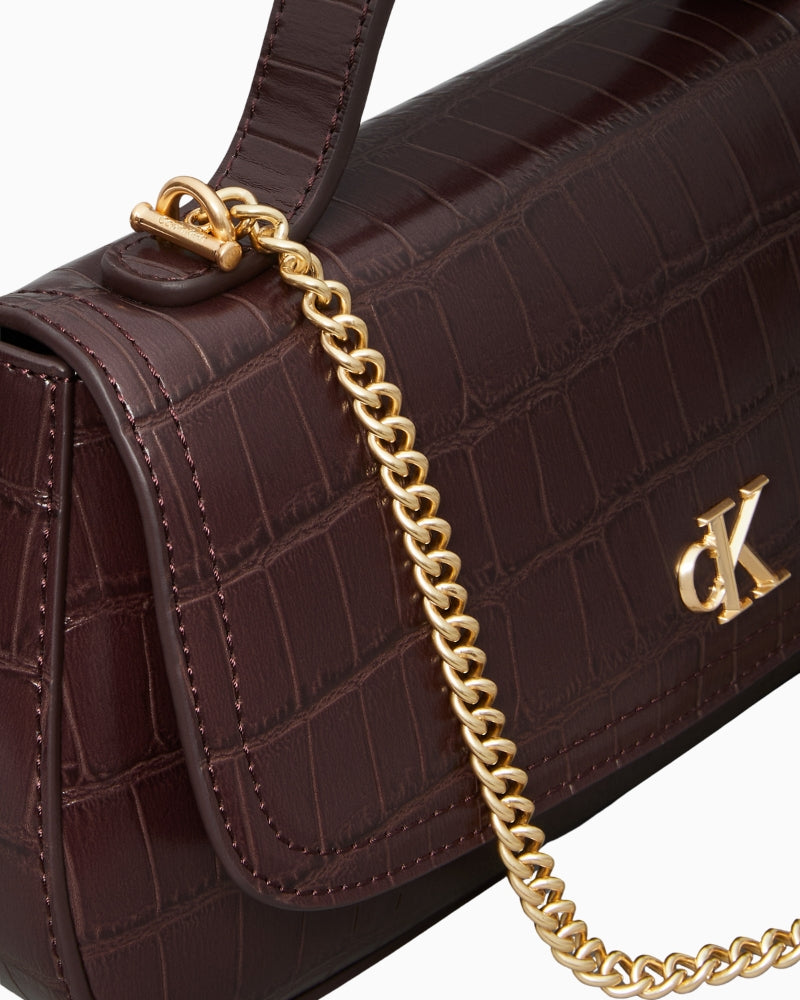 Close-up of chain strap and croc texture on Calvin Klein bag