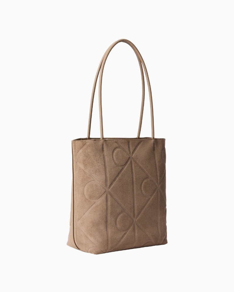 Calvin Klein emblem AOP suede tote side view – Áines Boutique