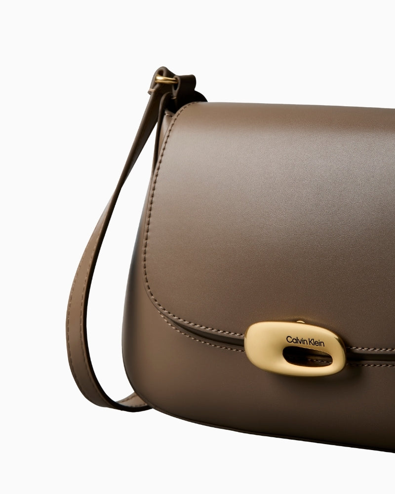 Calvin Klein hardware detail on taupe flap crossbody bag – Áines Boutique