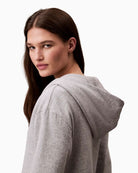 Side view of Calvin Klein hoodie showing relaxed fit and ribbed cuffs