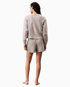 Back view of Calvin Klein pull-on lounge shorts with relaxed fit and logo waistband