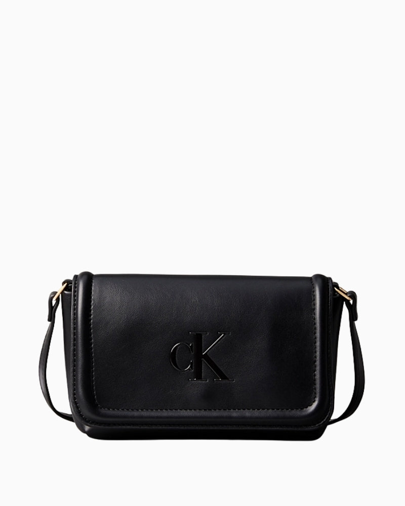 Front view of Calvin Klein soft-touch black crossbody bag with embossed logo