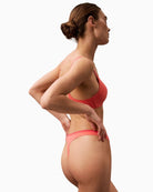 Side view of Calvin Klein recycled microfiber thong in violet shade