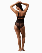 Back view of Calvin Klein bodysuit showing convertible straps and lace detail