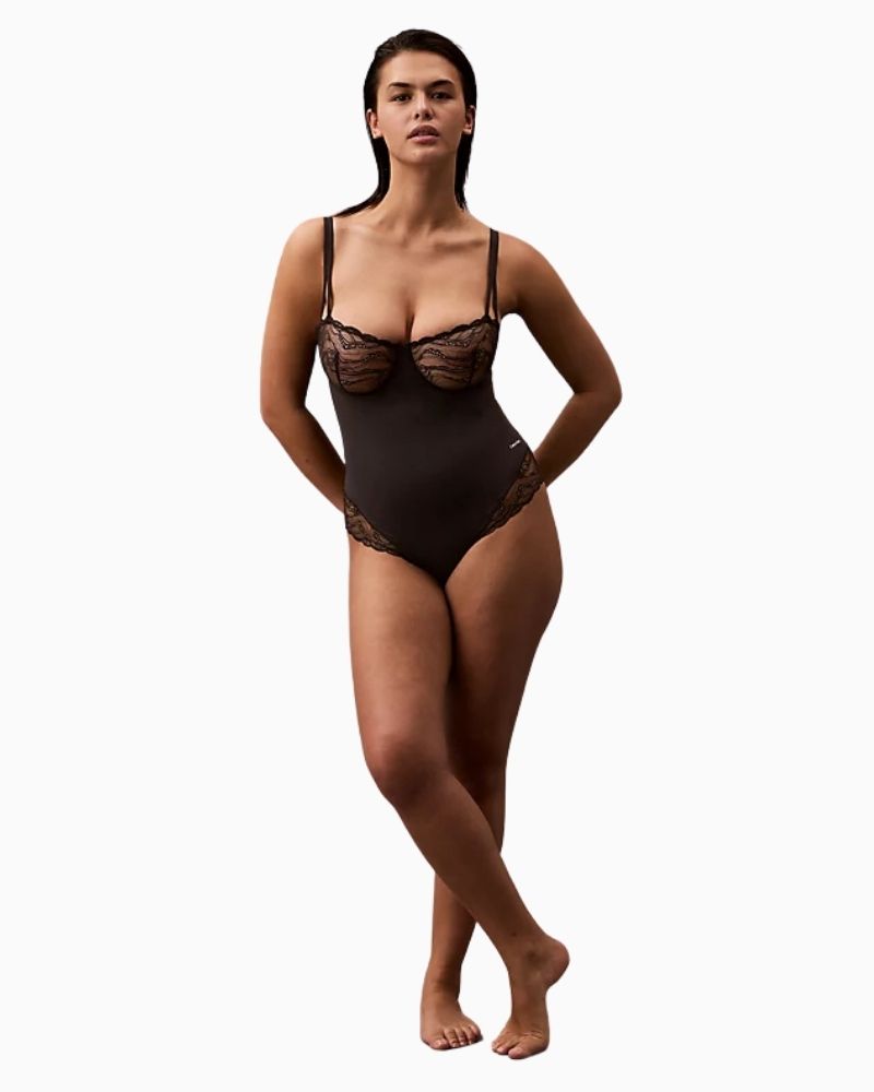 Model view of Calvin Klein bodysuit showing convertible straps and lace detail