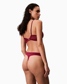 Flat lay of CK thong in soft pink polypropylene blend with logo detail