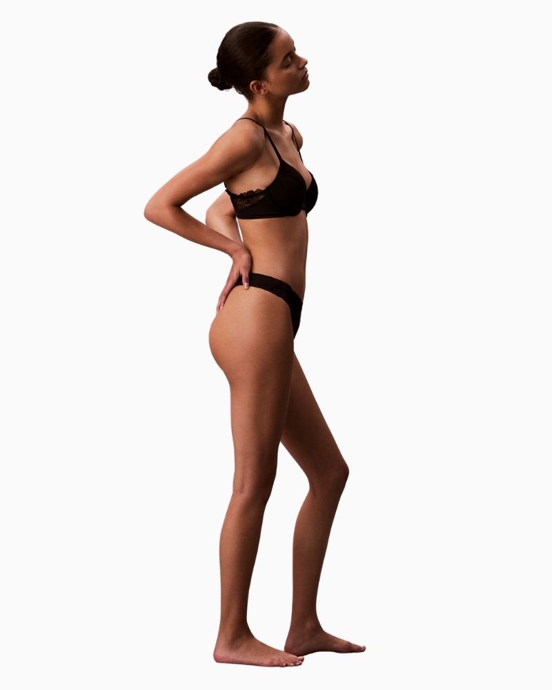 Side view of Lightweight CK thong in black stretch fabric laid flat