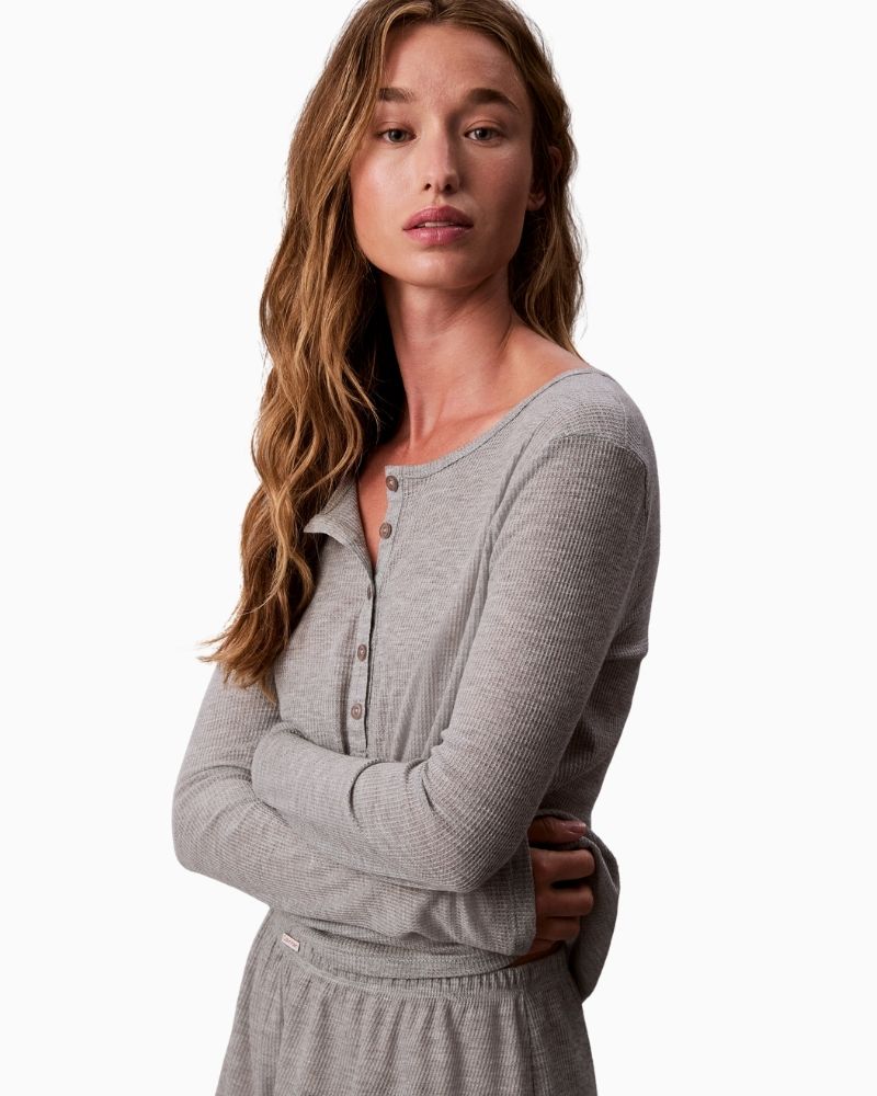 Close-up of textured waffle fabric and button placket on Calvin Klein lounge top