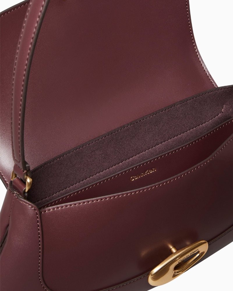 Close-up of Calvin Klein logo and faux leather texture