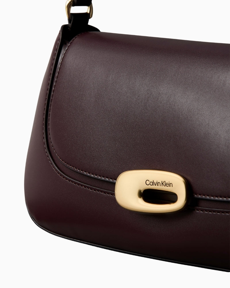 Close-up of Calvin Klein logo and faux leather texture