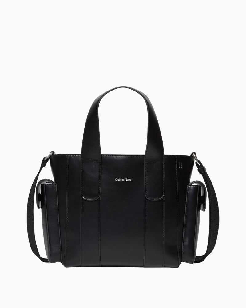Front view of Calvin Klein black tote with webbing shoulder straps and structured design
