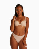 Calvin Klein Perfectly Fit Thong in nude with tonal logo waistband and soft microfiber fabric