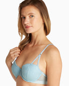 Close-up of model wearing Calvin Klein lightly padded balconette bra