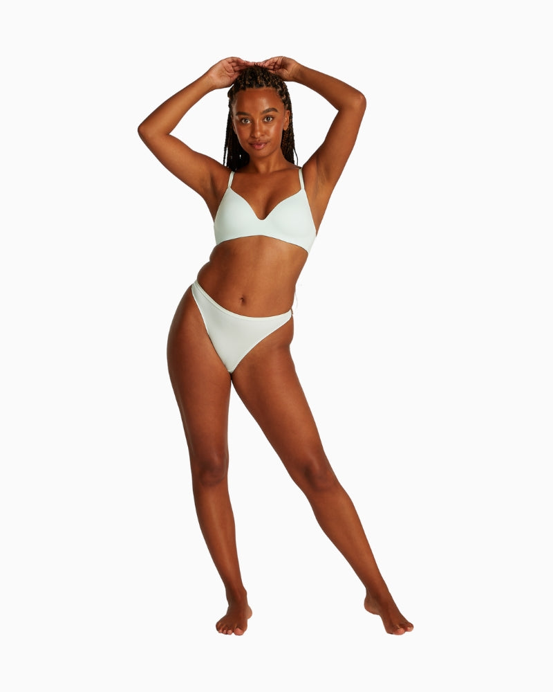 Full body view of model wearing Calvin Klein moonlight jade thong and matching bra