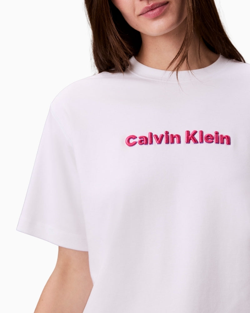 Close-up of CK logo tee showing textured embroidery and crew neckline