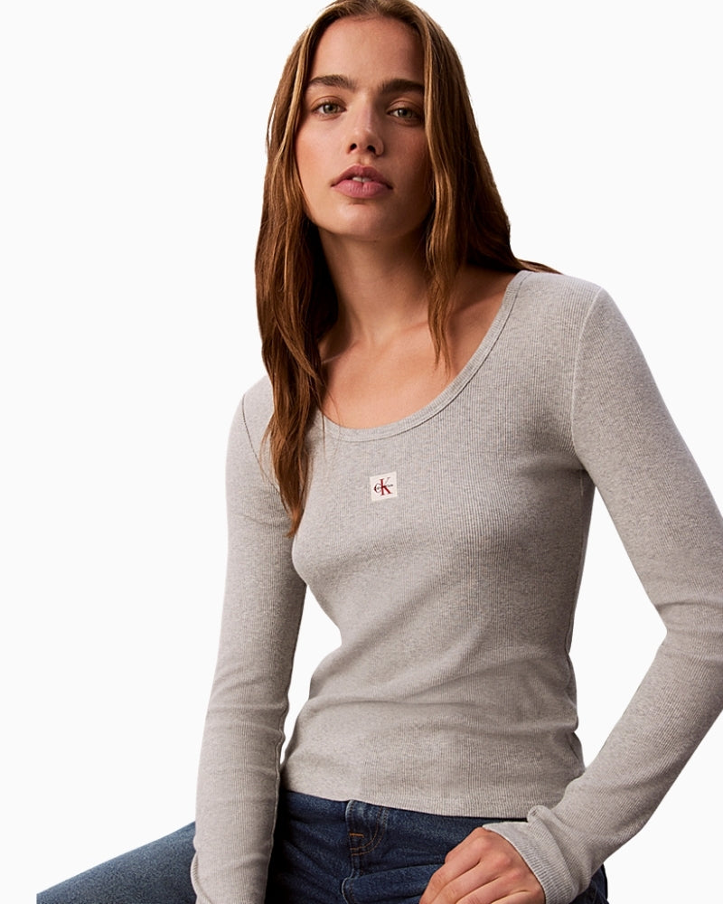 Front view of black ribbed CK long sleeve top showing monogram badge