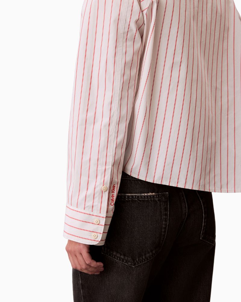 Close-up of stripe detail, collar, and button fastening