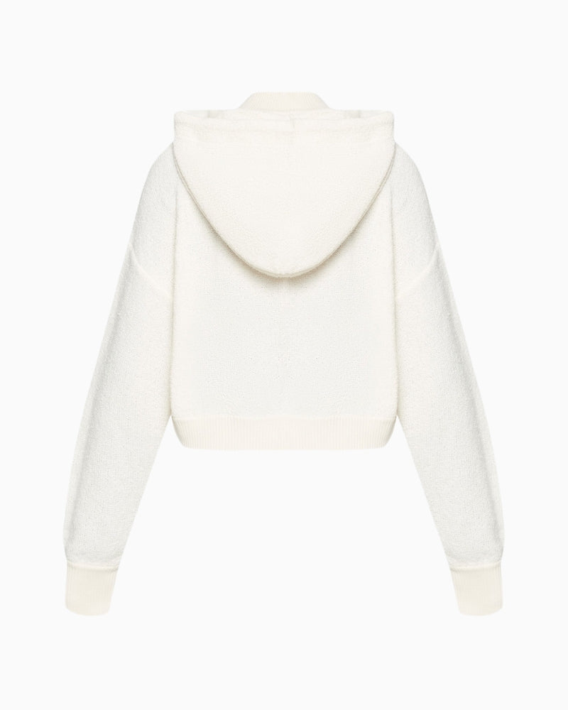 Back of women’s white hoodie showing straight cut and relaxed fit in textured cotton blend