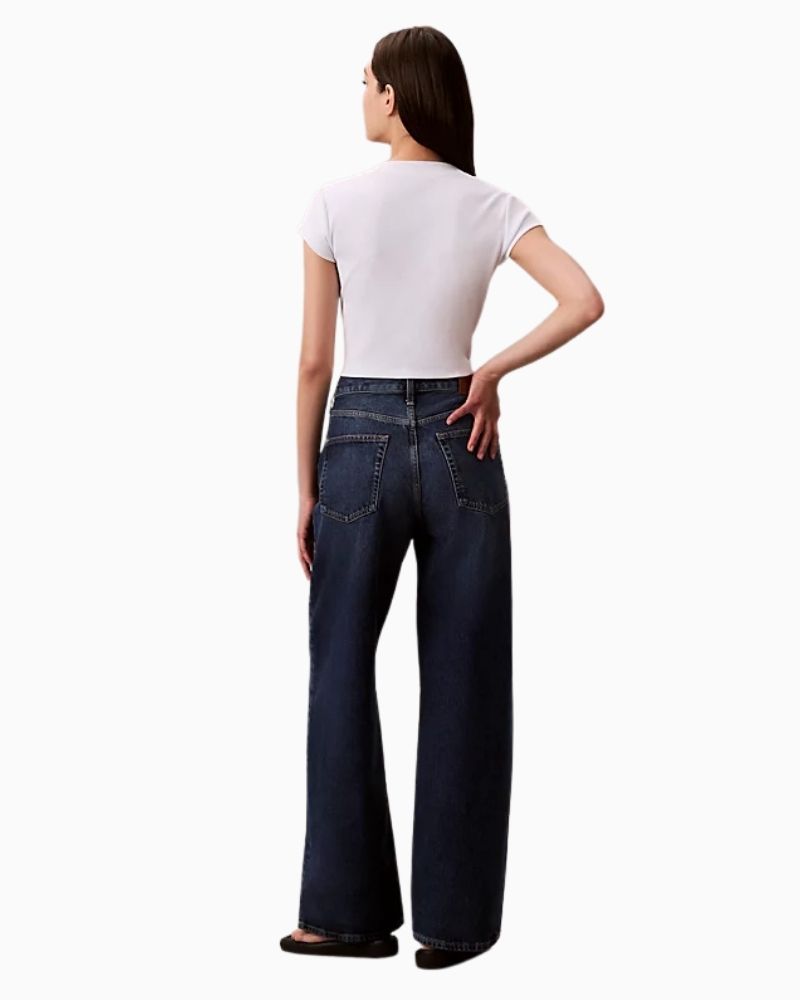 Back view of Calvin Klein jeans showing wide leg shape and branded leather patch