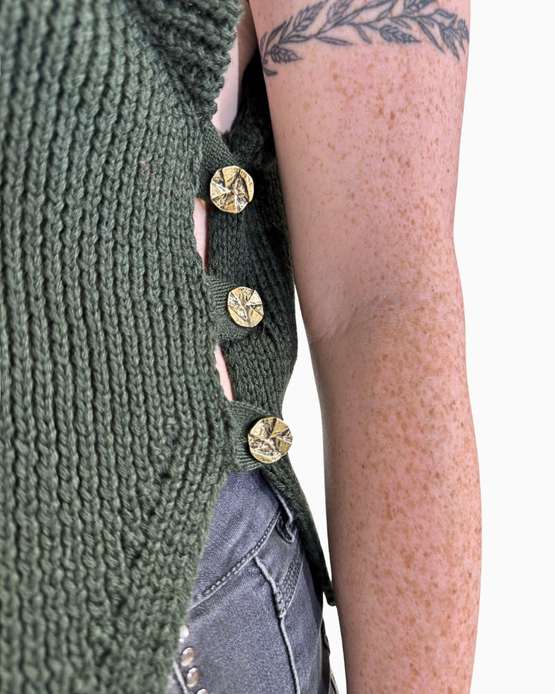 Close-up of khaki knit texture and ribbed detail on Eva Kayan vest