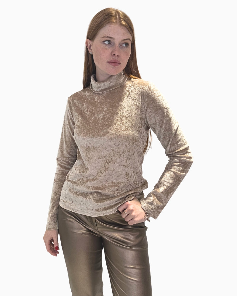 Front view of a woman wearing a slim-fit, beige crushed velvet poloneck top by Eva Kayan.