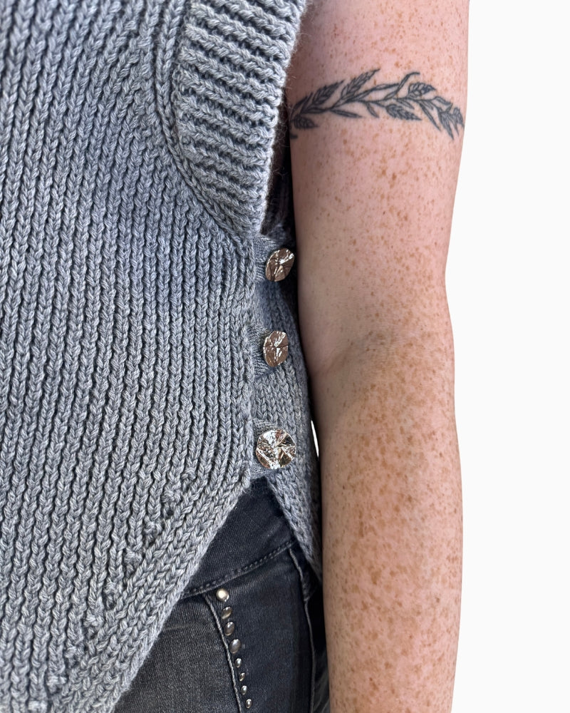 Closed-up view of dark grey Eva Kayan vest with side button detail