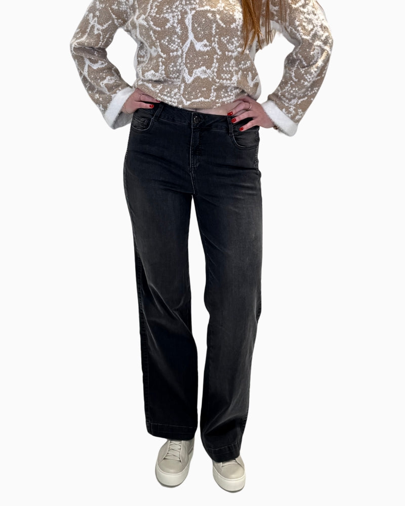 Front view of a woman wearing wide-leg dark grey denim jeans by Eva Kayan.