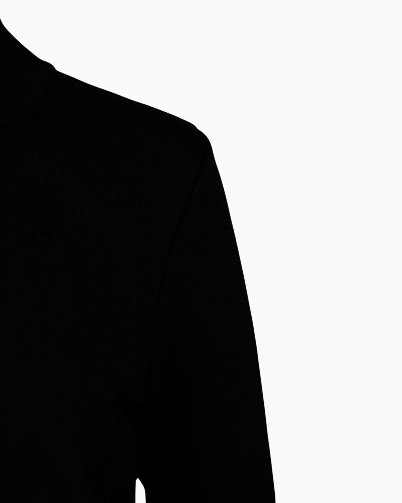 Close-up of sequin ribbon detail on Faber black turtleneck knit