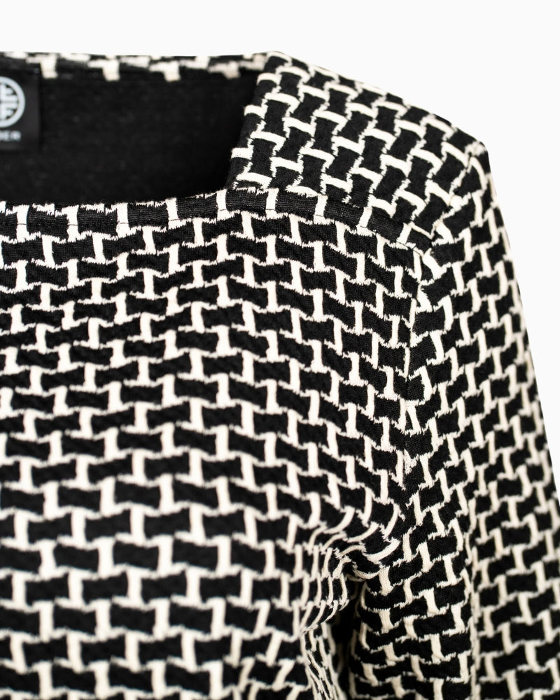 Close-up of woven texture and neckline detail on Faber square neck top
