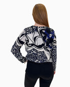 Back view of the mixed print jumper showing the bold pattern and elasticated hem