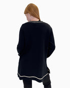 Back view of the Faber Woman fine-knit cardigan showing the simple design and full length