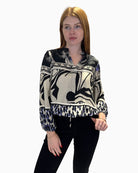 Front view of Faber Woman printed V-neck blouse showing mixed abstract patterns and ruffled collar