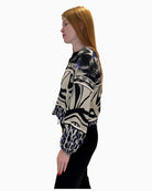 Side profile of the Faber Woman blouse showing the relaxed fit, balloon sleeves, and cuffed hem