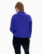 Back view of purple top by Faber Woman showing relaxed, flowing fit and short cap sleeves