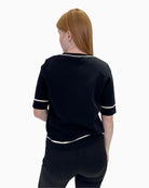 Back view of the Faber Woman 14603 jumper showing the simple black knit and white trim details