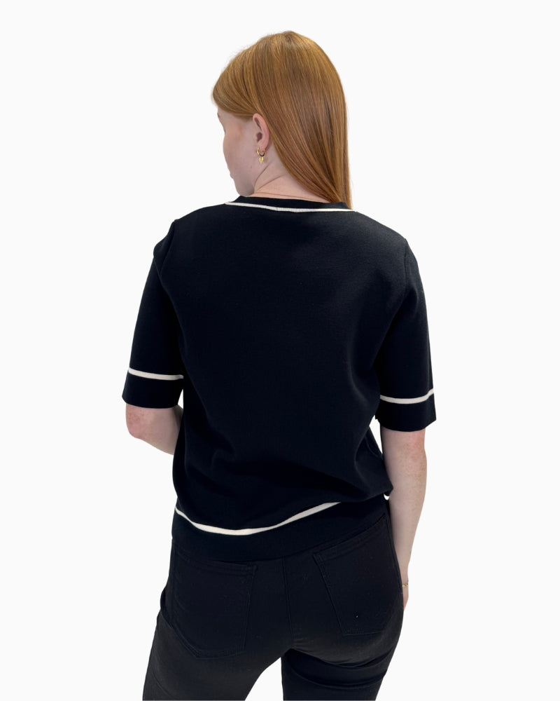 Back view of the Faber Woman 14603 jumper showing the simple black knit and white trim details