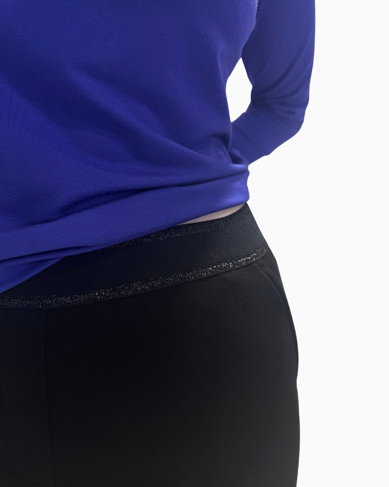 Close-up detail of the elasticated waistband on the Faber Woman trousers with a subtle sheen