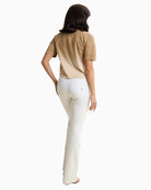 Side view of Freddy white full-length flare jeans with flattering flare silhouette