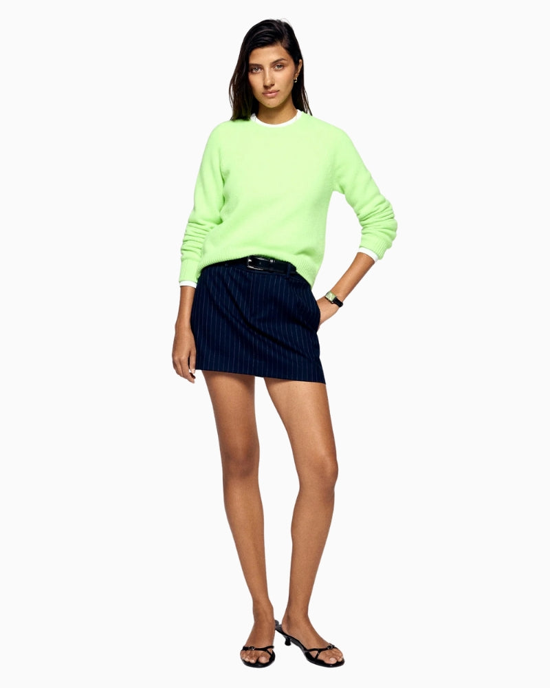 Women’s cropped cashmere sweater in bright green showing raglan sleeves