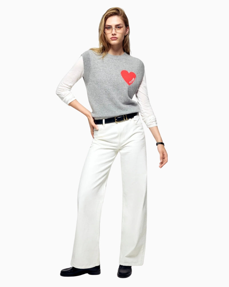 Styled look featuring sleeveless cashmere sweater layered over white shirt