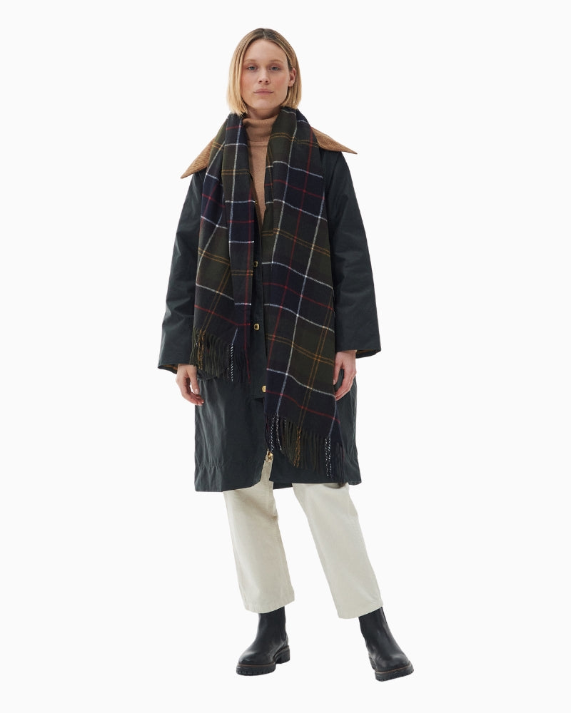 Full length styling of Barbour tartan scarf layered over coat outfit