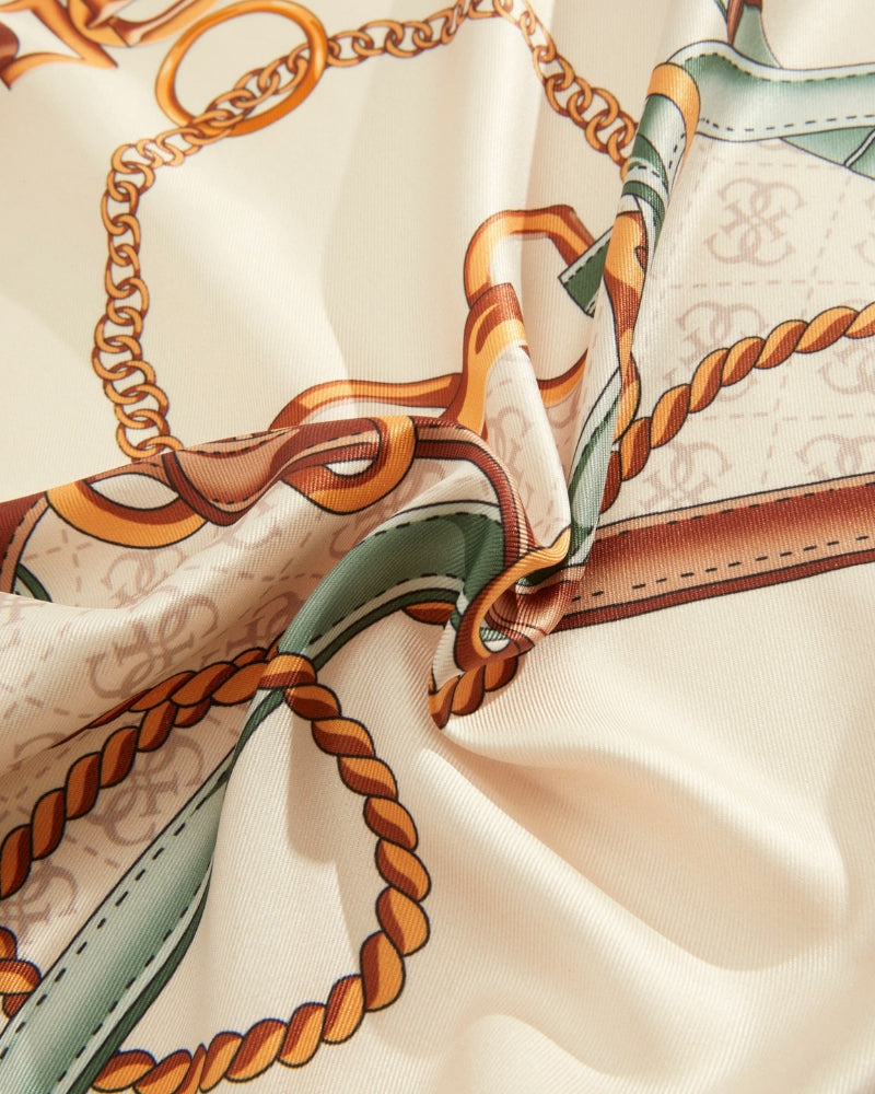 Close-up of Guess 4G scarf showing silky texture and detailed pattern