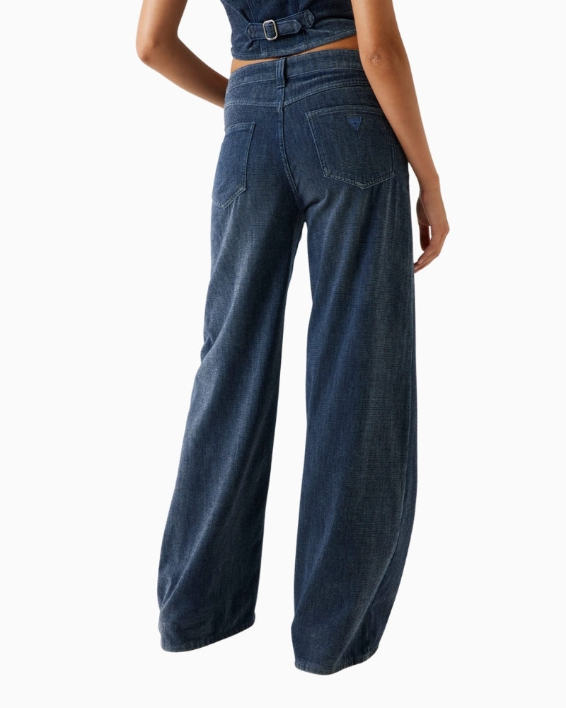 Back view showing relaxed leg and mid‑rise waist of Guess Bellflower jeans