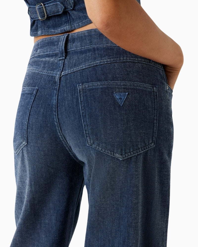 Detail of pocket stitching on dark blue Guess jeans