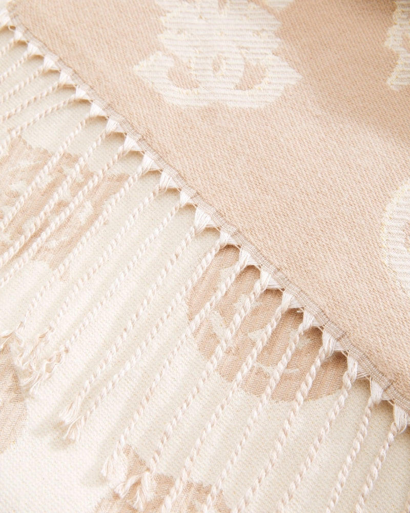 Close-up of beige Guess scarf showing delicate lurex thread